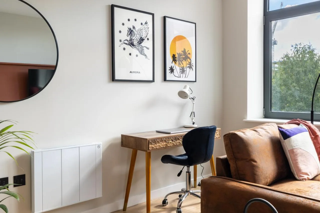 A living room with a desk and a couch at Kula Birmingham - New Street Station